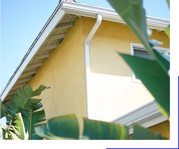 Freshly installed gutter and downspout in the roof of house.
